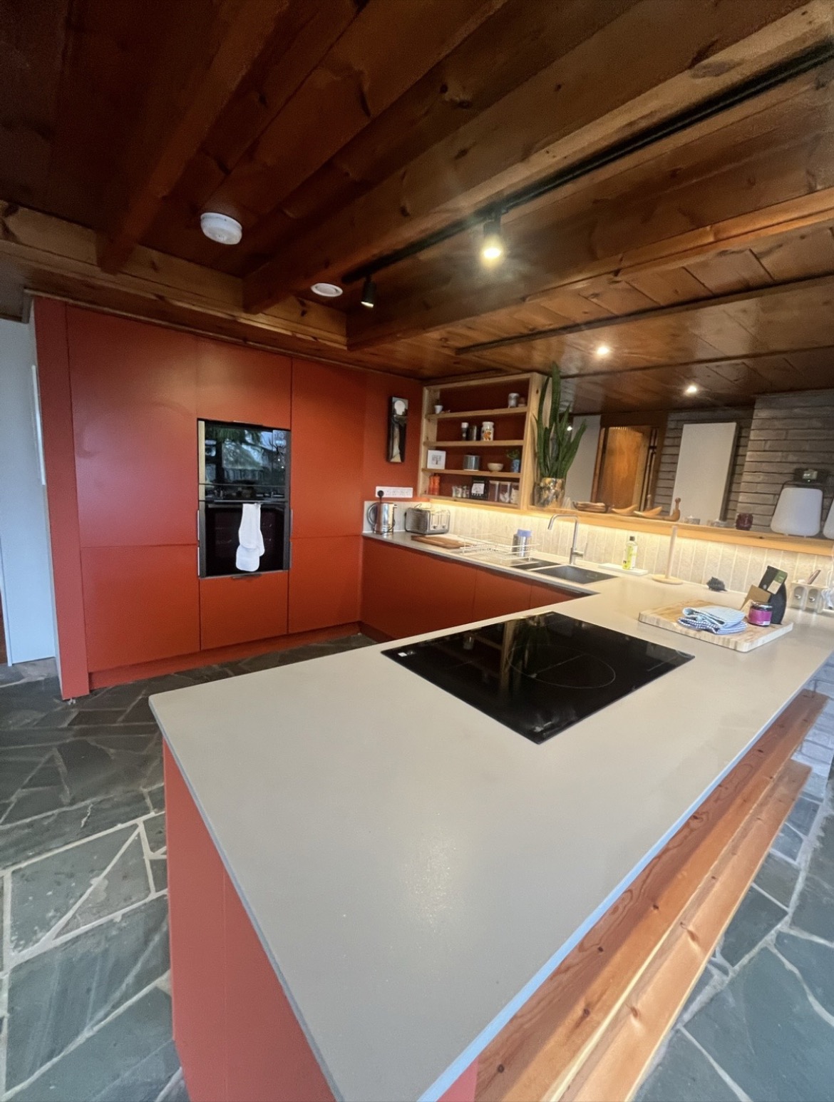 Kitchen interior of a Lake District holiday cottage with slate flooring and wooden beamed ceiling