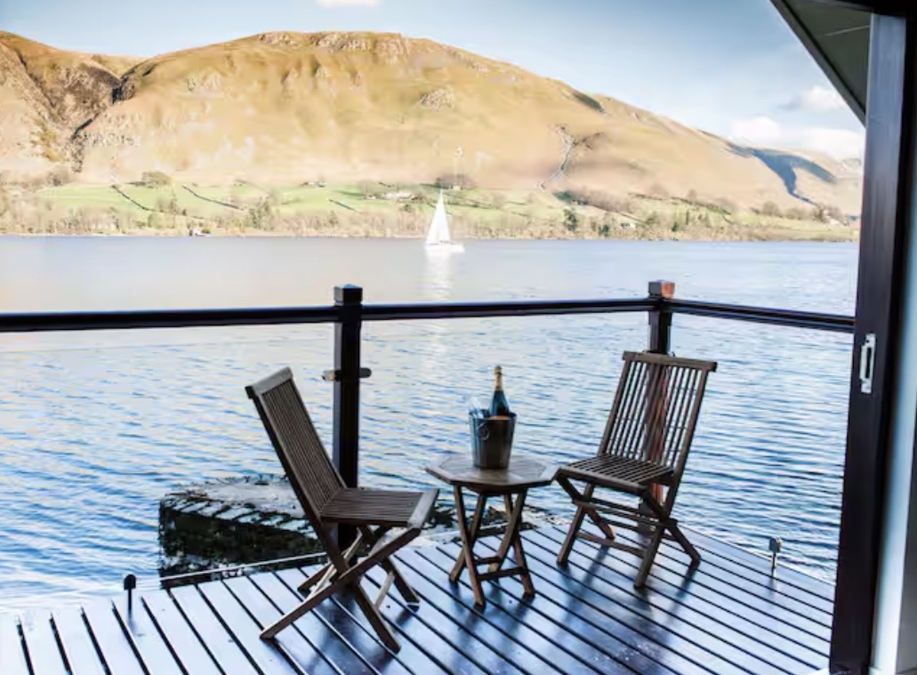 Balcony seating overlooking Ullswater with a sailing boat in the distance